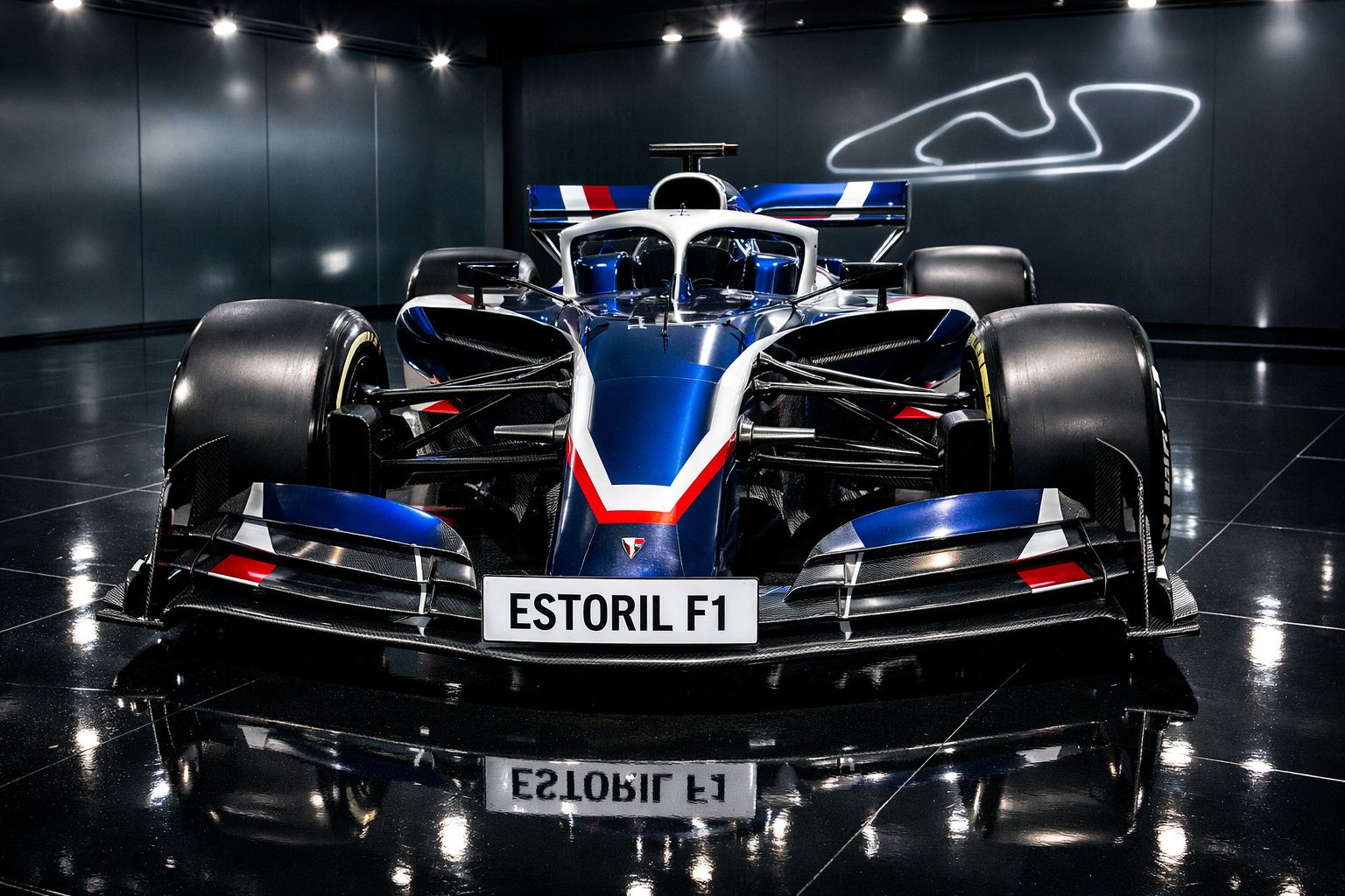 Carro de Fórmula 1 azul e preto com matrícula "ESTORIL F1" em exibição sob luzes artificiais.